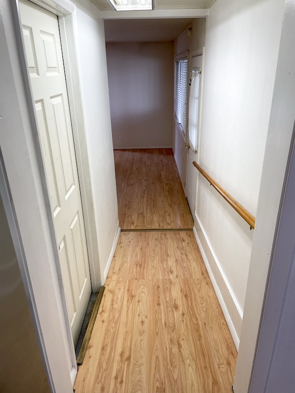 hall with light hardwood / wood-style floors