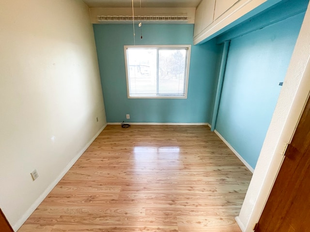 unfurnished bedroom with light hardwood / wood-style floors and a closet