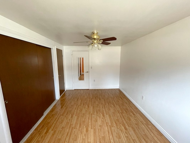 empty room with light hardwood / wood-style floors and ceiling fan