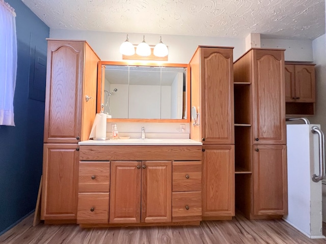 bathroom featuring vanity, a textured ceiling, and hardwood / wood-style flooring