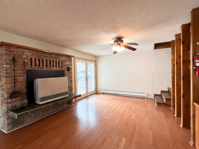 unfurnished living room with hardwood / wood-style floors, a textured ceiling, baseboard heating, and ceiling fan