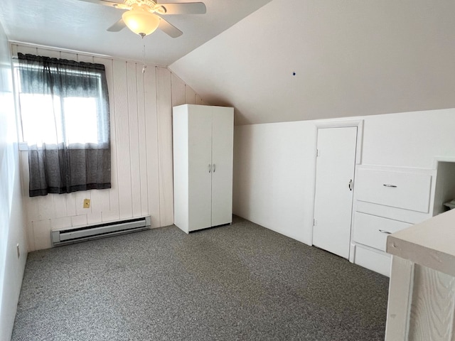 additional living space with ceiling fan, light carpet, lofted ceiling, and a baseboard heating unit