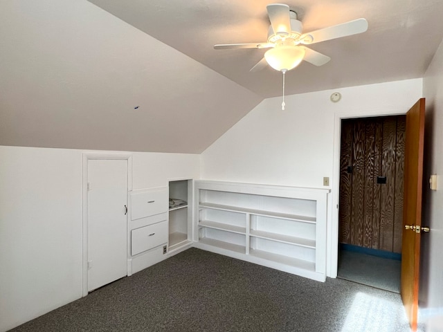 bonus room featuring dark carpet, vaulted ceiling, and ceiling fan