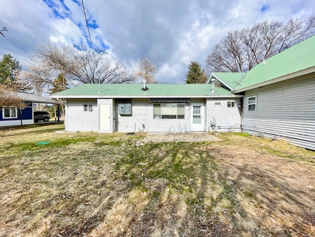 rear view of property featuring a yard