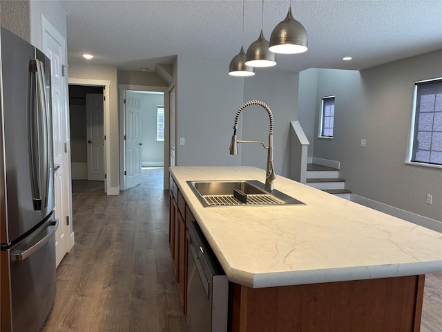4019 Lancaster Rd, Missoula, MT 59808 - kitchen featuring freestanding refrigerator, dishwashing machine, a textured ceiling, an island with sink, and dark wood-style floors
