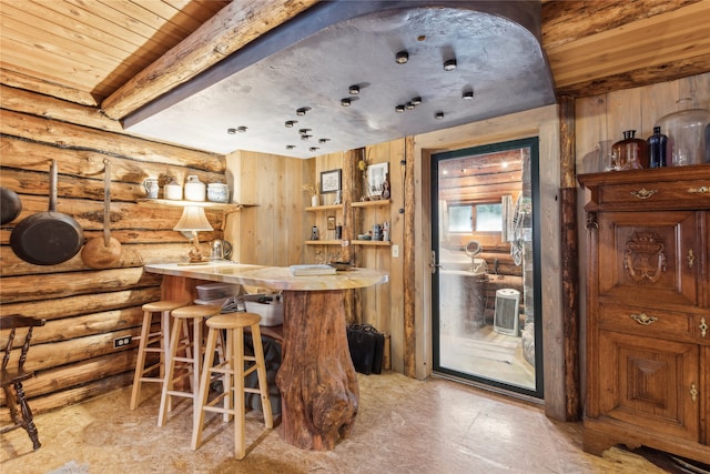 bar with beam ceiling, wooden ceiling, and rustic walls