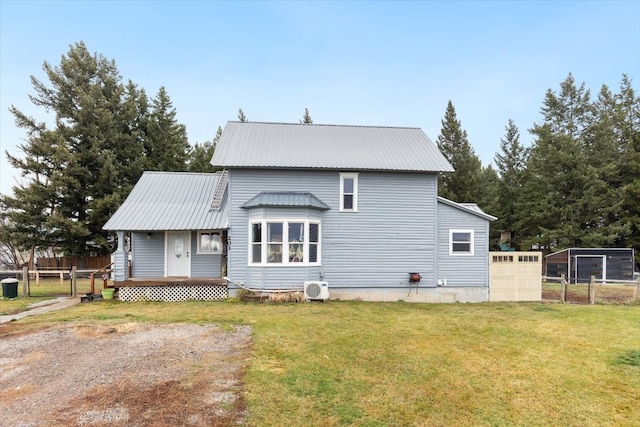 view of front facade with ac unit and a front yard