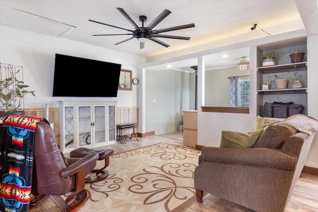 living room with ceiling fan and light wood-type flooring