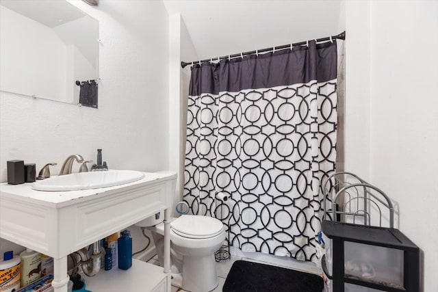 bathroom featuring tile patterned floors, curtained shower, toilet, and sink