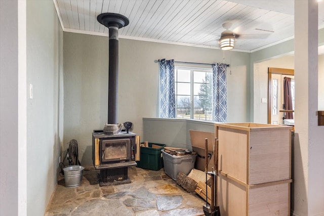 interior details featuring a wood stove, wooden ceiling, and ornamental molding