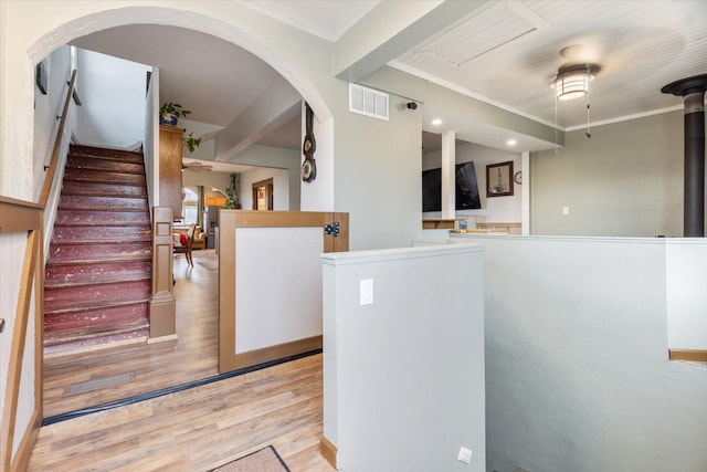 interior space with wood-type flooring and crown molding