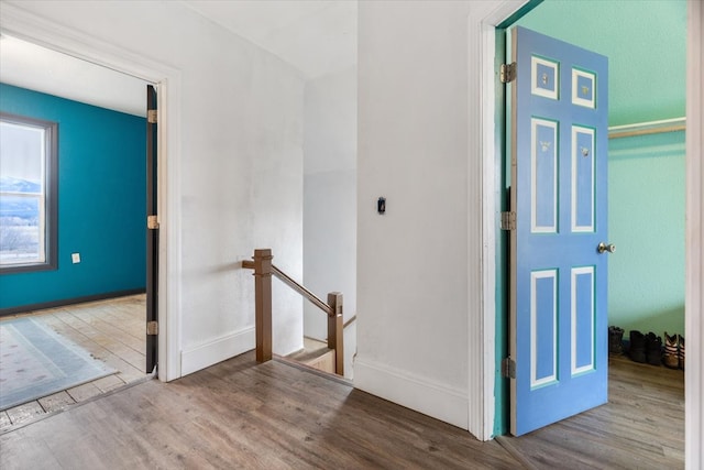 hallway with light hardwood / wood-style floors