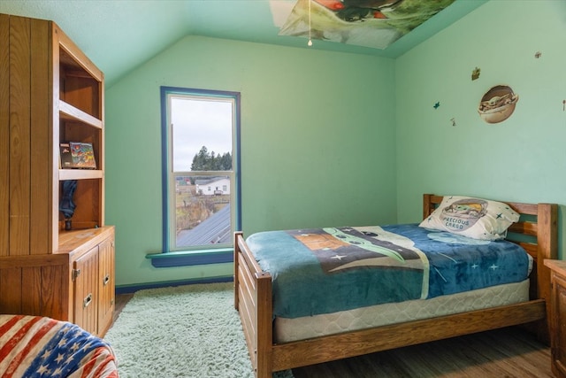 bedroom featuring wood-type flooring and vaulted ceiling