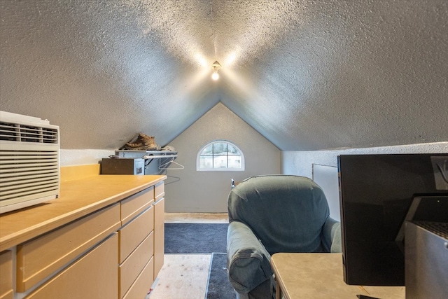 carpeted home office featuring lofted ceiling and a textured ceiling