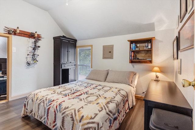 bedroom featuring electric panel, lofted ceiling, and dark hardwood / wood-style floors