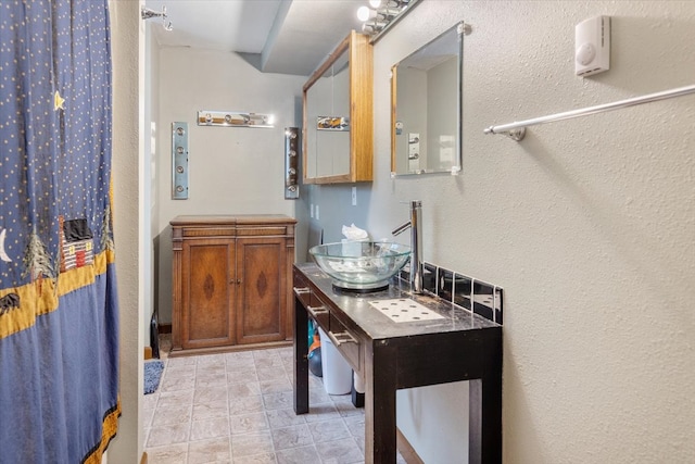 bathroom with a shower with shower curtain and vanity