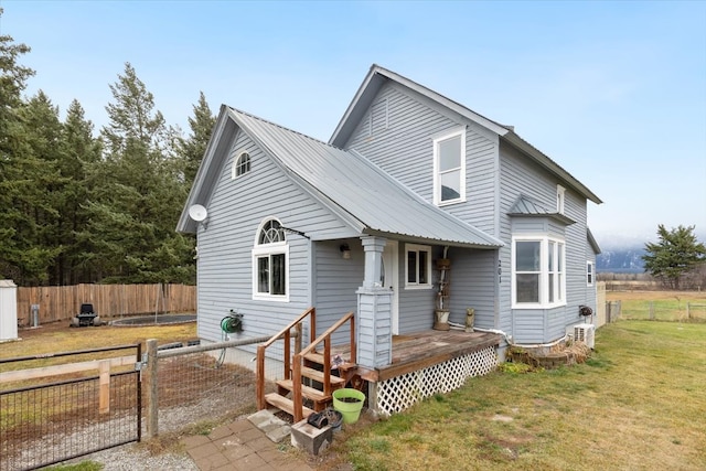 rear view of property with a yard and a deck