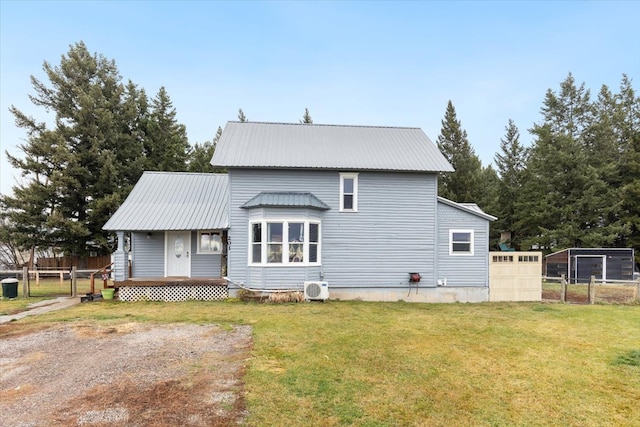 view of front of house featuring ac unit and a front lawn