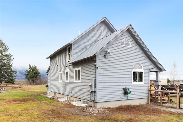 view of side of home featuring a lawn