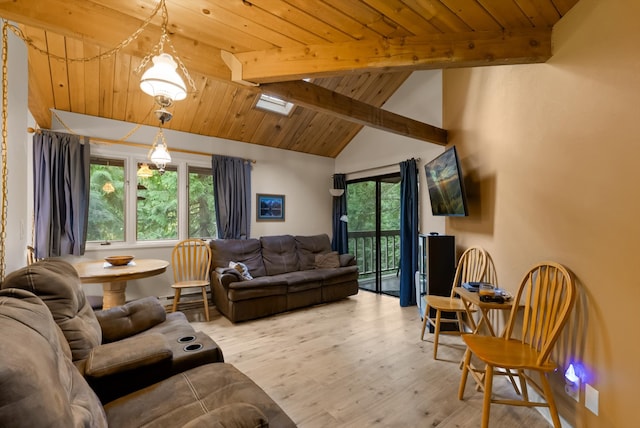 living room featuring vaulted ceiling with skylight, a healthy amount of sunlight, wood ceiling, and light hardwood / wood-style flooring