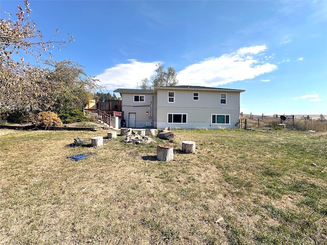 back of house with a lawn and a wooden deck