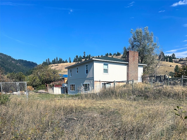 rear view of house with a mountain view