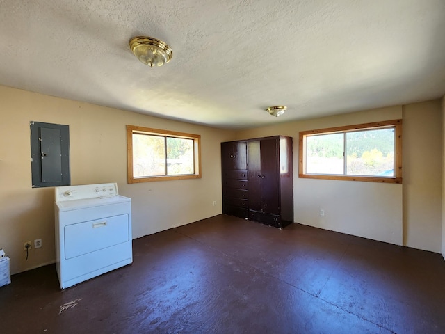 laundry room with washer / clothes dryer, electric panel, and a textured ceiling