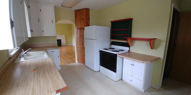 kitchen featuring light hardwood / wood-style floors, white cabinetry, white appliances, and sink