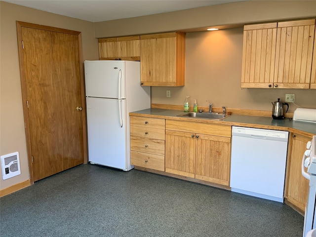 kitchen with light brown cabinetry, white appliances, heating unit, and sink