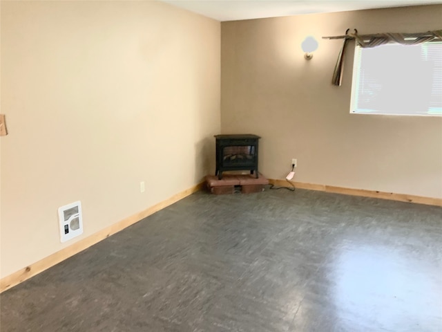 spare room featuring a wood stove