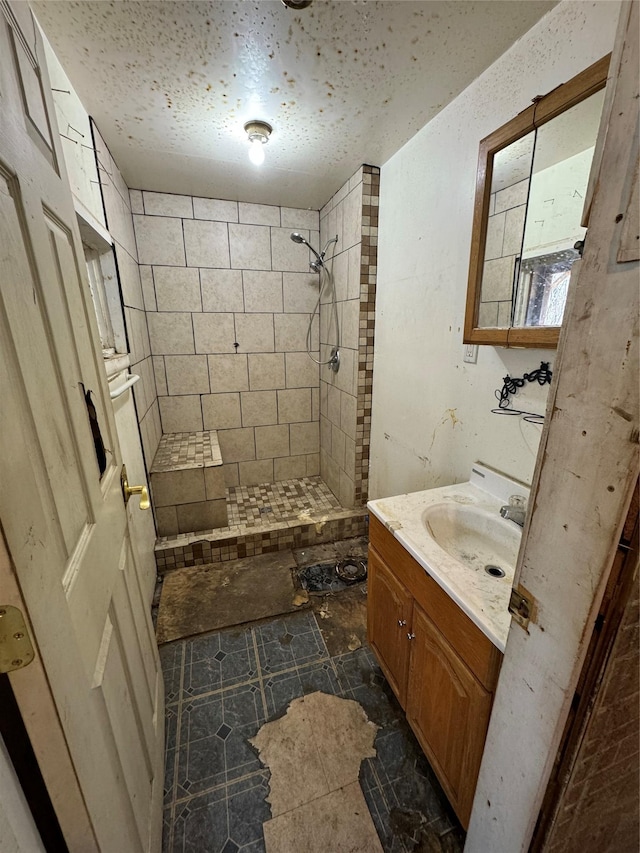 703 Birch St, Anaconda, MT 59711 - bathroom featuring a tile shower, vanity, and a textured ceiling