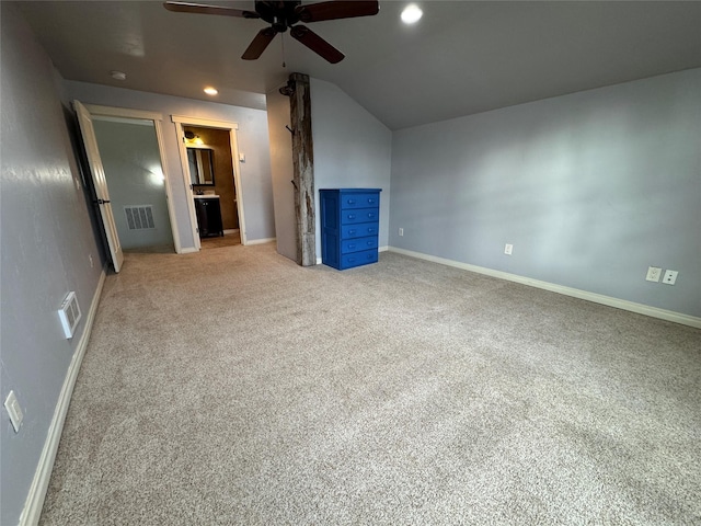 126 Moes Run, Kalispell, MT 59901 - unfurnished living room with light carpet, a ceiling fan, baseboards, lofted ceiling, and visible vents