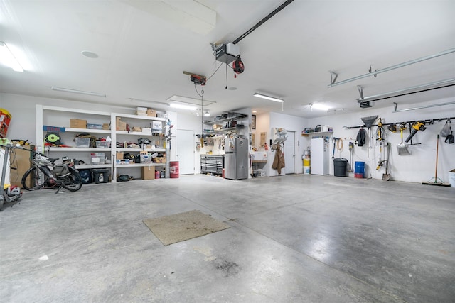 126 Moes Run, Kalispell, MT 59901 - garage with freestanding refrigerator, a garage door opener, heating unit, and a workshop area