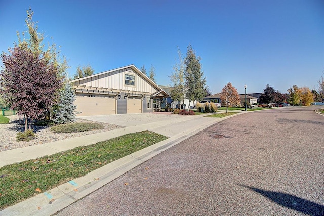 126 Moes Run, Kalispell, MT 59901 - view of front of house with board and batten siding, a residential view, concrete driveway, and a garage