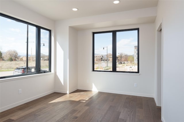 empty room with dark hardwood / wood-style floors