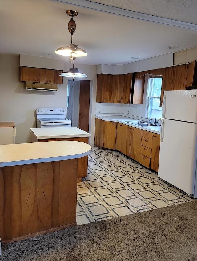 kitchen featuring sink, kitchen peninsula, pendant lighting, light colored carpet, and white appliances