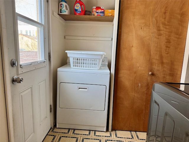 clothes washing area with washing machine and clothes dryer