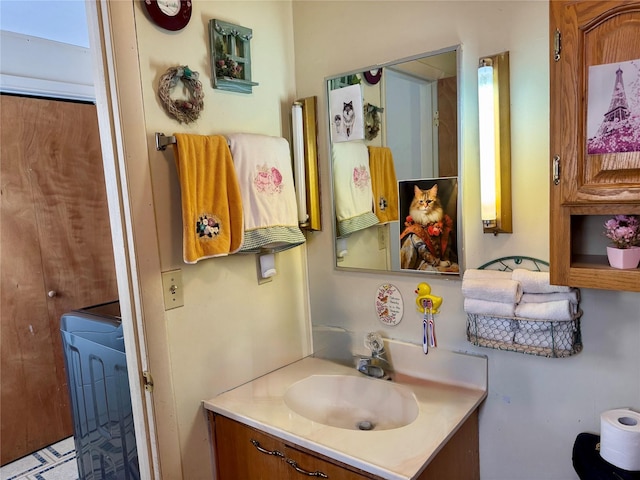 bathroom with vanity and washer / dryer