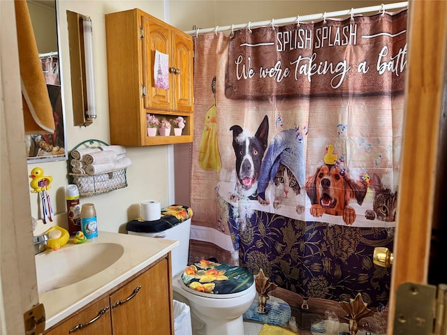 bathroom featuring vanity, toilet, and walk in shower