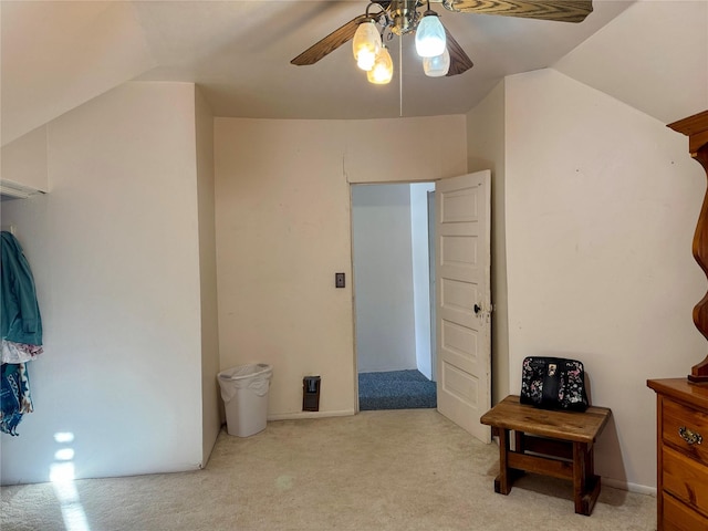 interior space featuring light colored carpet, ceiling fan, and lofted ceiling