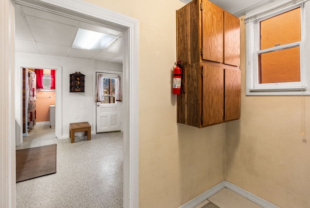 corridor with a paneled ceiling