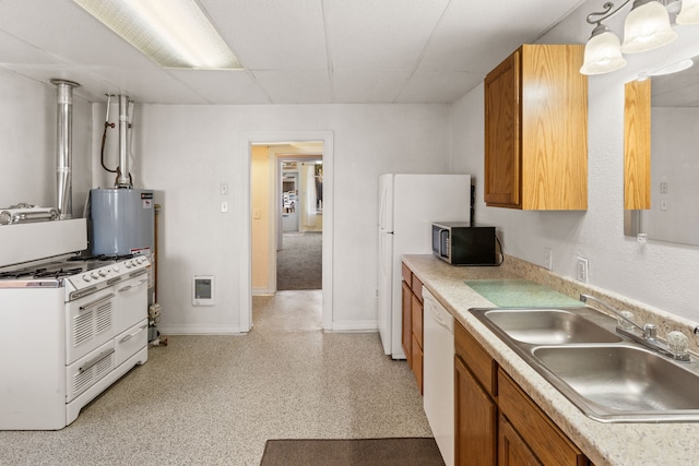 kitchen with sink, water heater, heating unit, pendant lighting, and white appliances