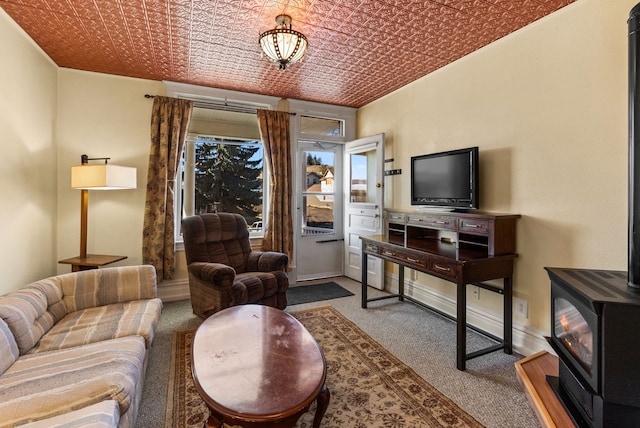 living room with a wood stove and carpet floors