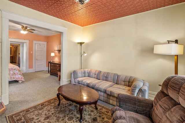 living room with ceiling fan and carpet floors