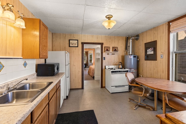 kitchen with white gas range, sink, tasteful backsplash, water heater, and wood walls