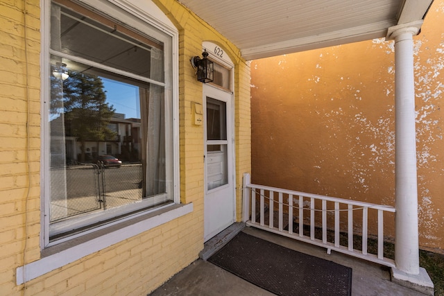 view of exterior entry with a porch