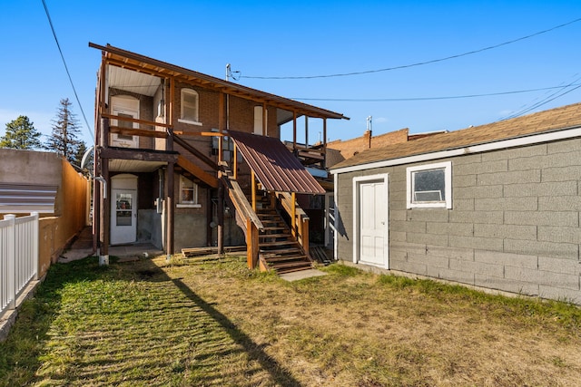 rear view of property with a yard