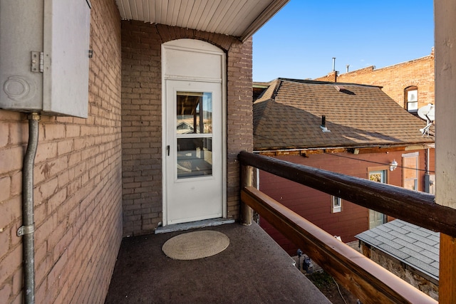 view of exterior entry with a balcony