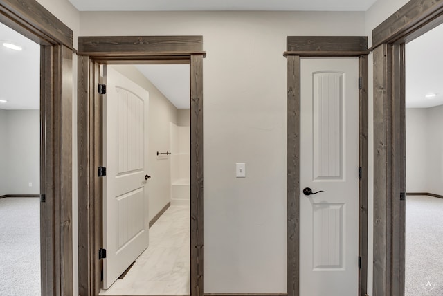 hallway with light colored carpet