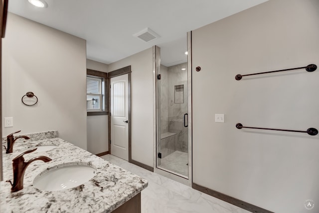 bathroom featuring vanity and a shower with shower door